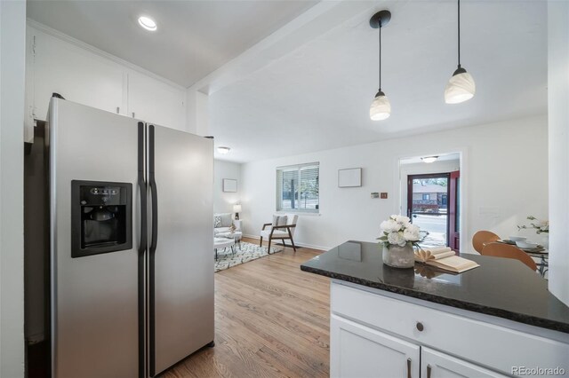 7275 E 8th Ave, Denver, CO 80220 - kitchen with stainless steel fridge, white cabinetry, decorative light fixtures, light wood-type flooring, and dark stone counters