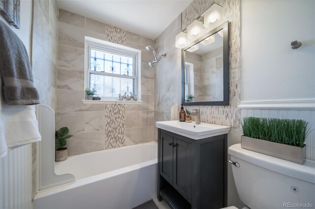 7275 E 8th Ave, Denver, CO 80220 - full bathroom with tile walls, shower / bathtub combination, toilet, and vanity