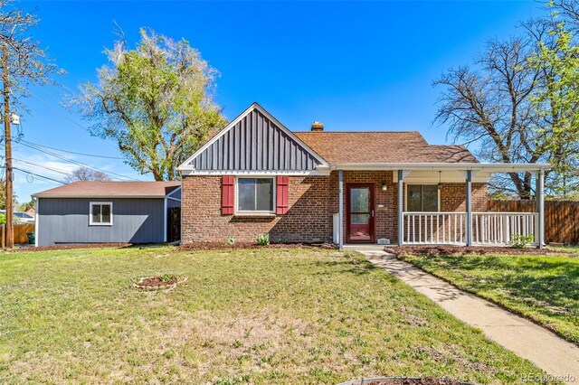7275 E 8th Ave, Denver, CO 80220 - view of front of house with brick siding, board and batten siding, a chimney, and covered porch