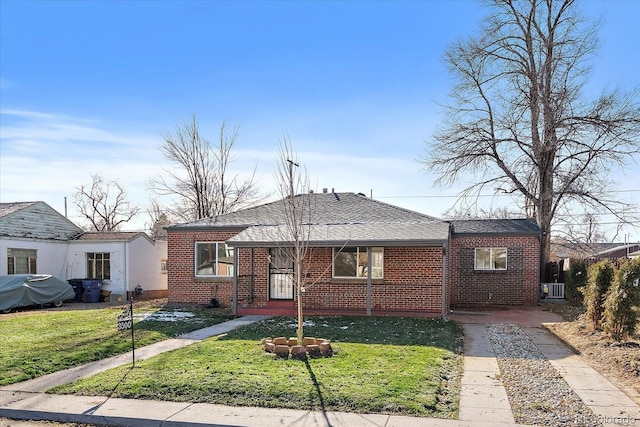 ranch-style house featuring central AC and a front lawn