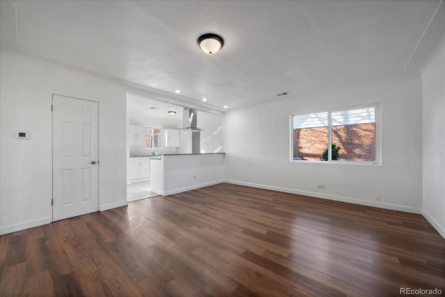 unfurnished living room with dark hardwood / wood-style floors