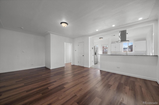 unfurnished living room featuring dark hardwood / wood-style floors