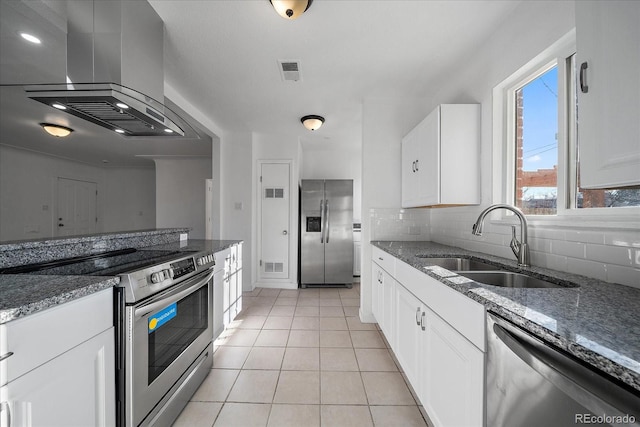 kitchen with sink, light tile patterned floors, white cabinetry, stainless steel appliances, and extractor fan