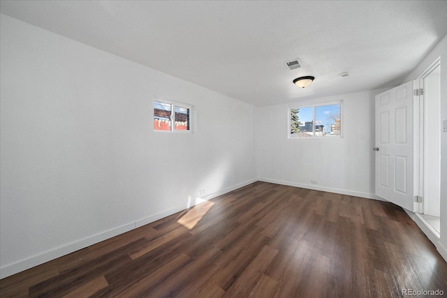 unfurnished room with dark hardwood / wood-style floors