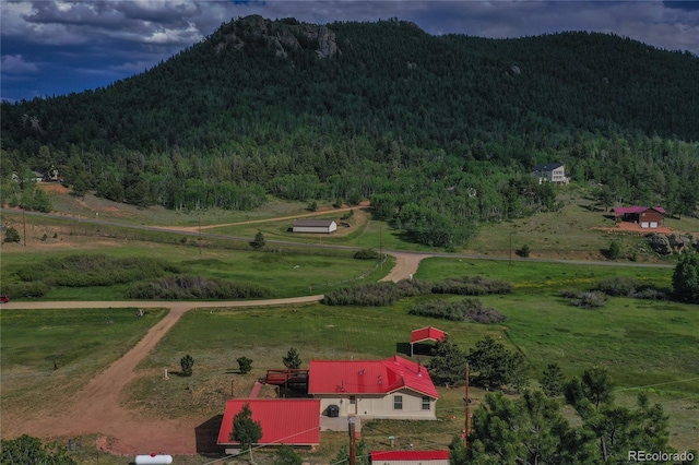 birds eye view of property with a mountain view and a rural view