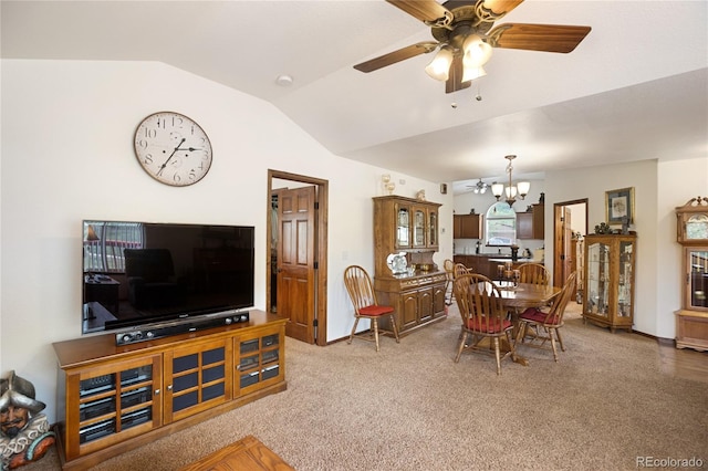 living room featuring light carpet, ceiling fan with notable chandelier, and lofted ceiling