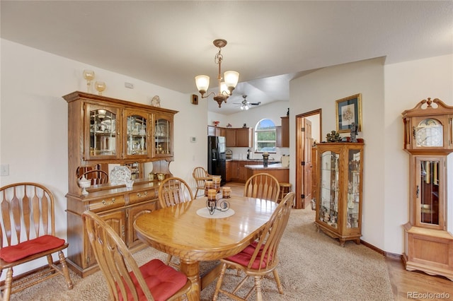 dining area featuring light wood-type flooring and ceiling fan with notable chandelier