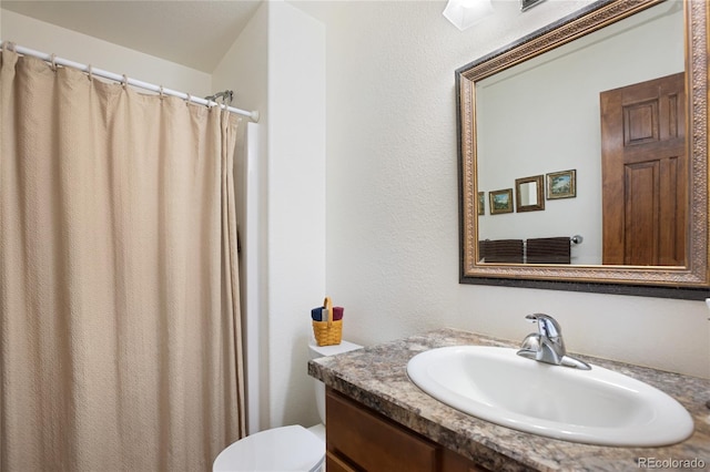 bathroom featuring toilet and vanity