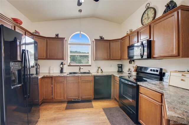 kitchen featuring light hardwood / wood-style flooring, black appliances, vaulted ceiling, pendant lighting, and ceiling fan