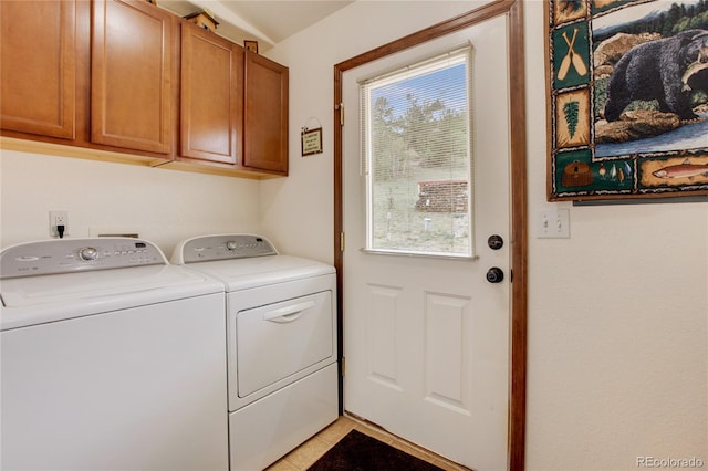 laundry area with cabinets, independent washer and dryer, and light tile patterned floors