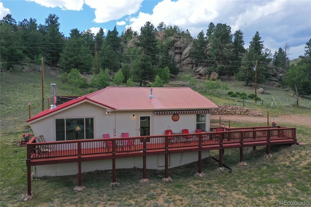 back of property featuring a wooden deck