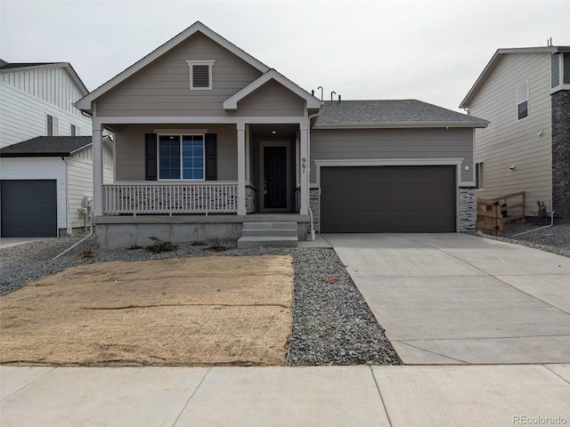 view of front of property with covered porch, driveway, and a garage