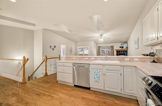 kitchen featuring white cabinetry, stainless steel appliances, sink, and light hardwood / wood-style flooring