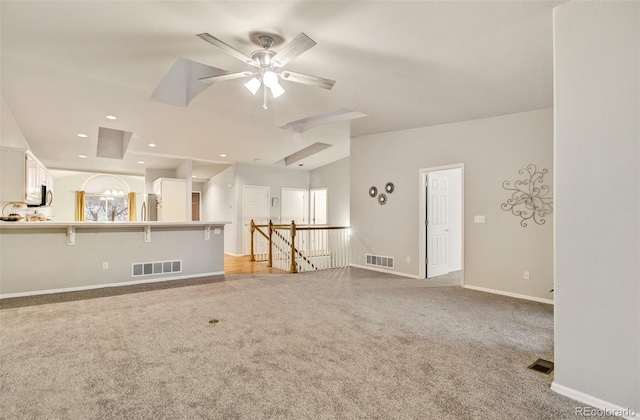 unfurnished living room featuring light colored carpet and ceiling fan