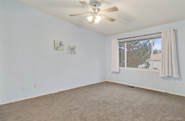 spare room featuring ceiling fan and carpet floors