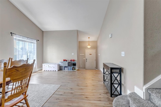 16352 E 104th Way, Commerce City, CO 80022 - dining room featuring light wood-style flooring and high vaulted ceiling