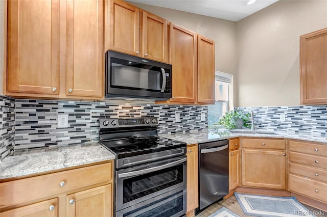 16352 E 104th Way, Commerce City, CO 80022 - kitchen with stainless steel range with electric cooktop, dishwashing machine, black microwave, and light stone counters