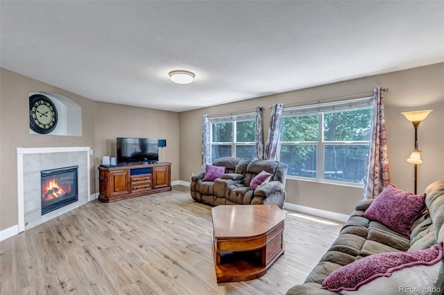 16352 E 104th Way, Commerce City, CO 80022 - living area with light wood-type flooring and a tiled fireplace
