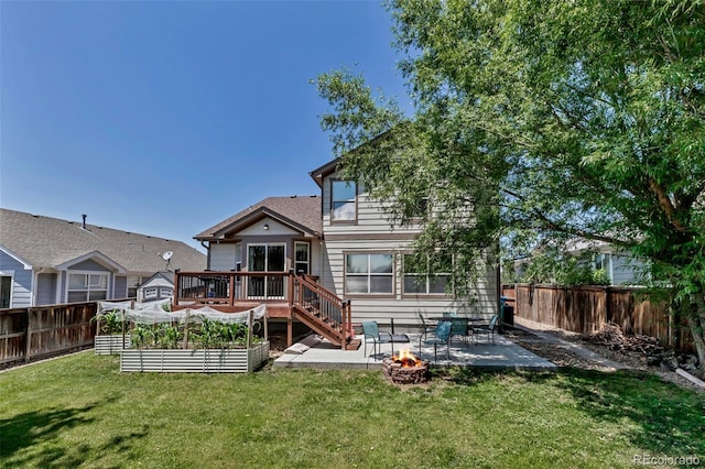 16352 E 104th Way, Commerce City, CO 80022 - rear view of property with a fire pit, a fenced backyard, a deck, a patio, and a garden