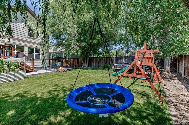 16352 E 104th Way, Commerce City, CO 80022 - view of playground with a trampoline, an outdoor fire pit, and a fenced backyard