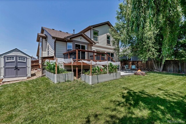 16352 E 104th Way, Commerce City, CO 80022 - rear view of house featuring a garden, a storage shed, a fenced backyard, a deck, and an outdoor fire pit