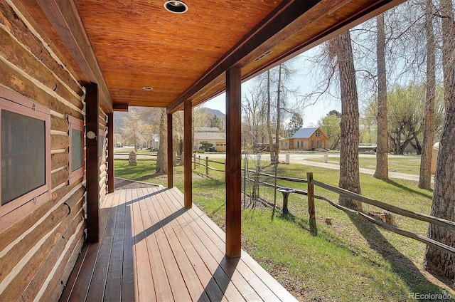 deck featuring a lawn and covered porch