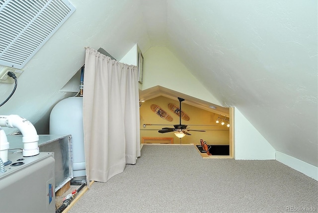 additional living space featuring carpet floors, ceiling fan, and vaulted ceiling