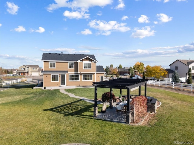 back of property featuring a pergola and a yard