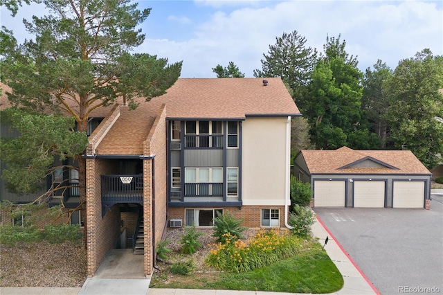 850 W Moorhead Cir Unit 3L, Boulder, CO 80305 - view of front of home featuring stairway, roof with shingles, and brick siding