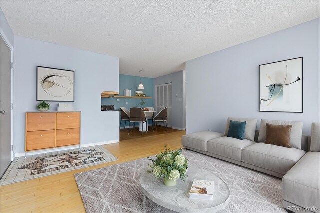 850 W Moorhead Cir Unit 3L, Boulder, CO 80305 - living room with wood finished floors and a textured ceiling