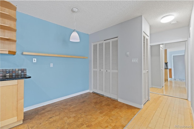 850 W Moorhead Cir Unit 3L, Boulder, CO 80305 - unfurnished dining area featuring wood finished floors and a textured ceiling