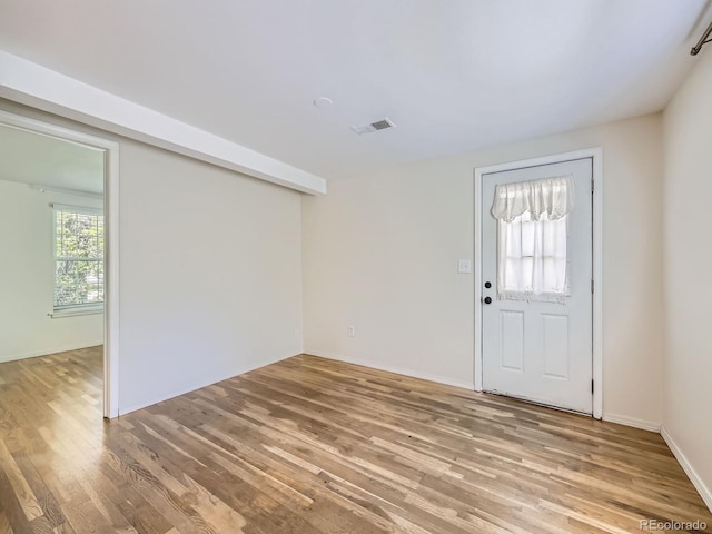 entryway with light wood-style flooring and baseboards
