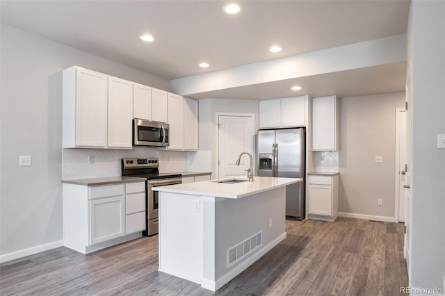 2561 Stage Coach Dr Unit B, Milliken, CO 80543 - kitchen with stainless steel appliances, a sink, tasteful backsplash, light wood-type flooring, and recessed lighting