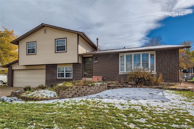 tri-level home featuring brick siding, concrete driveway, and a garage