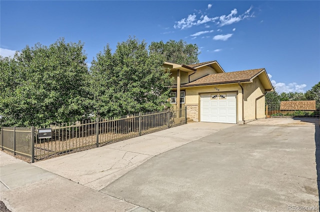 view of property exterior with concrete driveway, fence, a garage, and stucco siding