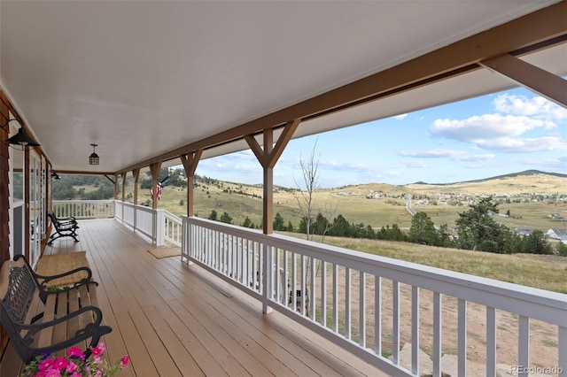 wooden deck with a rural view