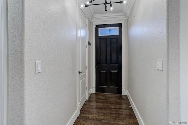 doorway to outside featuring dark hardwood / wood-style floors, crown molding, and an inviting chandelier