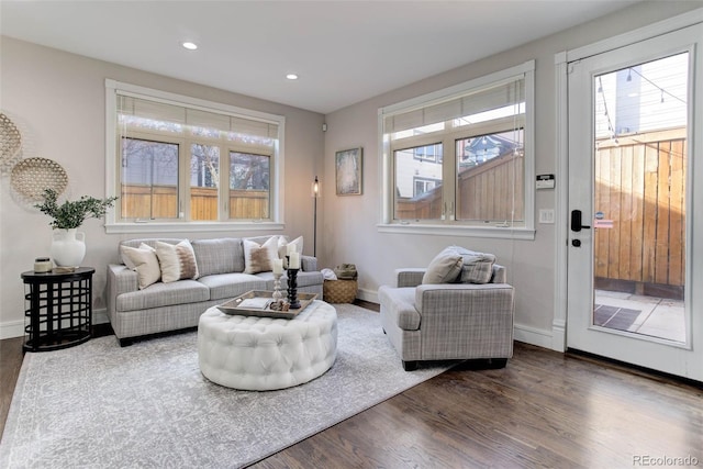 living room featuring plenty of natural light and dark hardwood / wood-style flooring