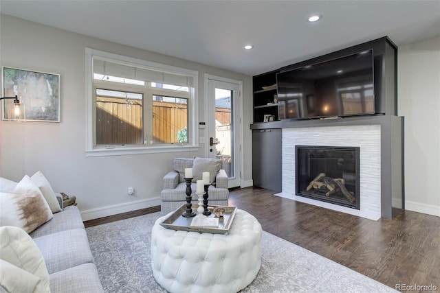 living room featuring built in shelves and dark wood-type flooring