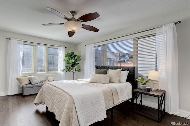 bedroom with dark hardwood / wood-style flooring and ceiling fan