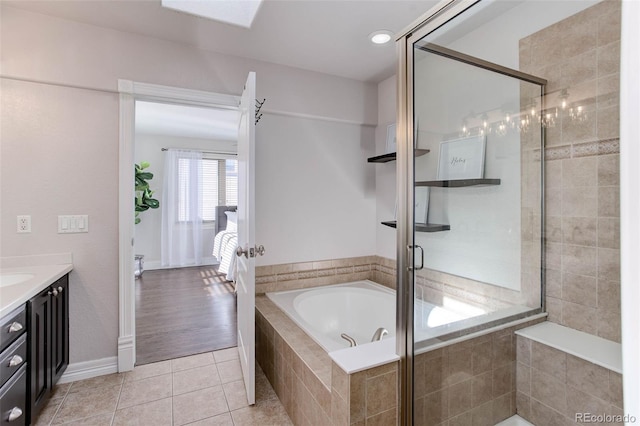 bathroom with tile patterned flooring, vanity, and independent shower and bath