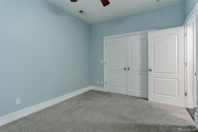 unfurnished bedroom with ceiling fan, a closet, and light colored carpet