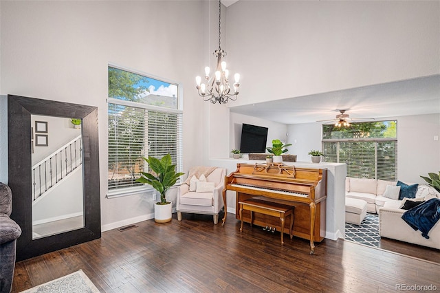 11681 Night Heron Dr, Parker, CO 80134 - living area with wood-type flooring, baseboards, a chandelier, a towering ceiling, and stairway
