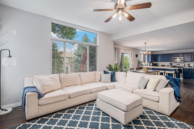 11681 Night Heron Dr, Parker, CO 80134 - living room featuring dark wood-style flooring, a chandelier, baseboards, and ceiling fan