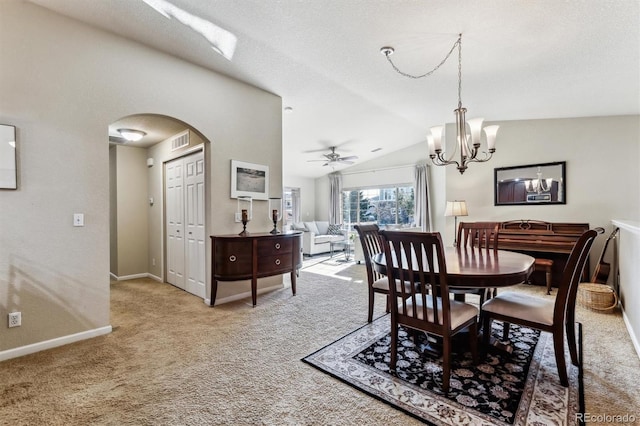 carpeted dining room with vaulted ceiling, ceiling fan with notable chandelier, and a textured ceiling