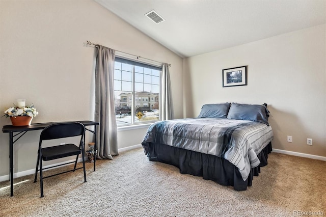 bedroom featuring lofted ceiling and carpet