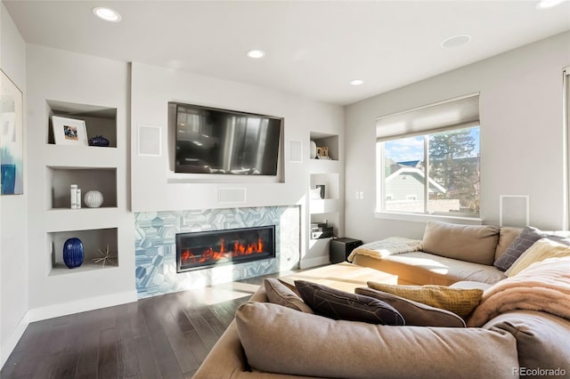 living room with hardwood / wood-style flooring and built in shelves