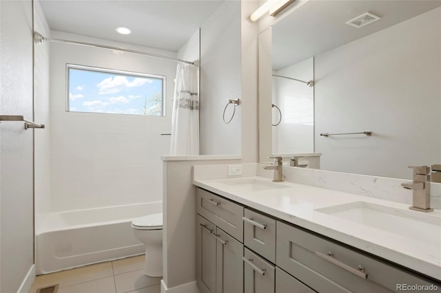 full bathroom featuring tile patterned floors, vanity, toilet, and shower / bath combo with shower curtain