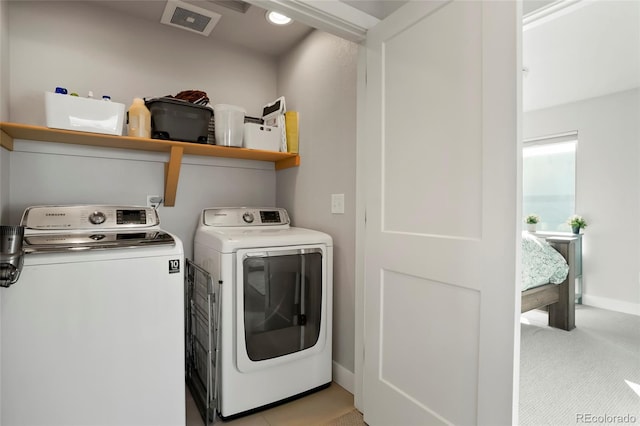 clothes washing area with washer and dryer