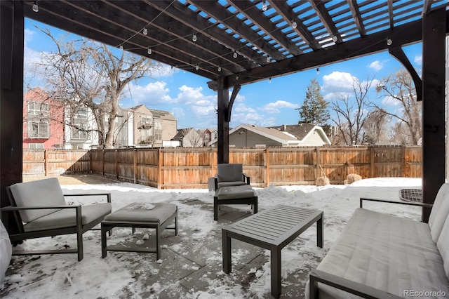 snow covered patio with a pergola